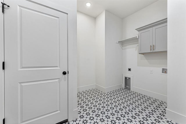 laundry room with electric dryer hookup, hookup for a washing machine, and cabinets