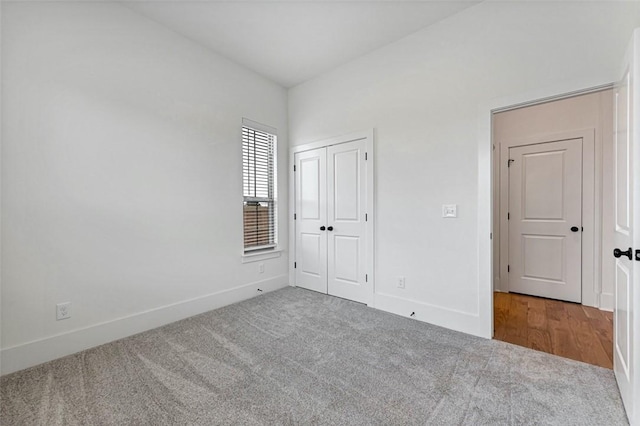 unfurnished bedroom with carpet flooring and a closet