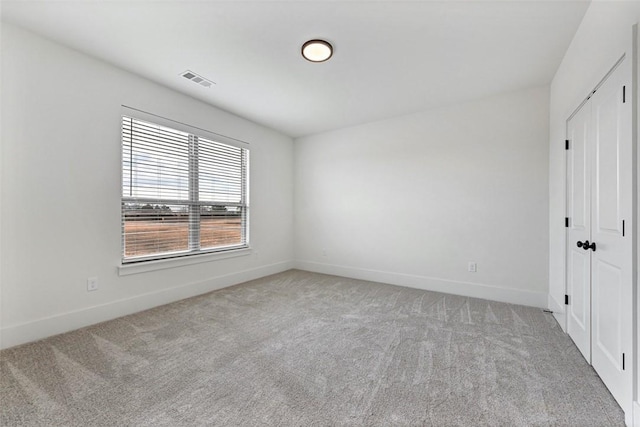 empty room featuring light colored carpet