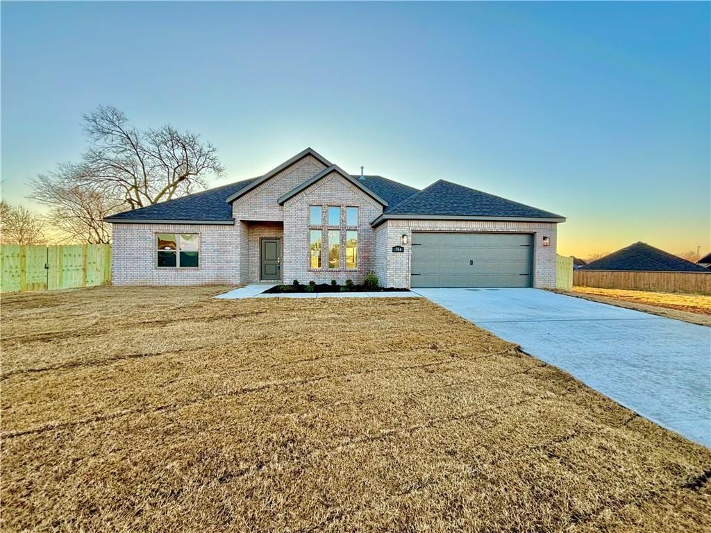 view of front of property with a yard and a garage