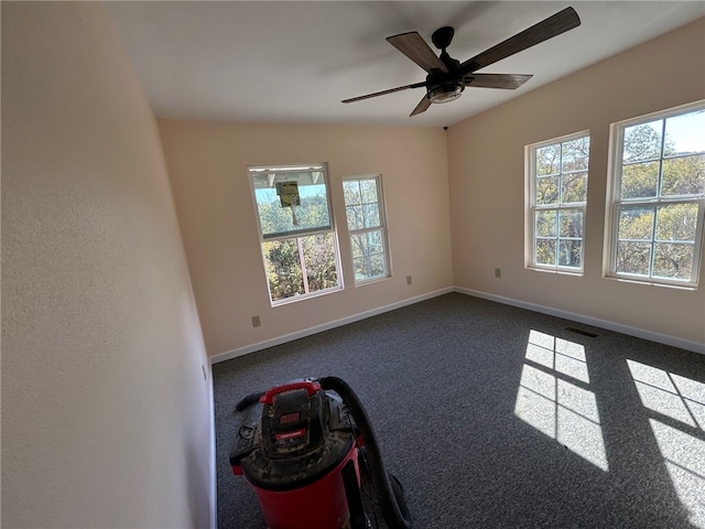 empty room with carpet floors, vaulted ceiling, and ceiling fan