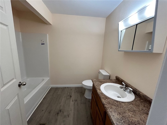 full bathroom featuring hardwood / wood-style flooring, vanity, toilet, and shower / washtub combination