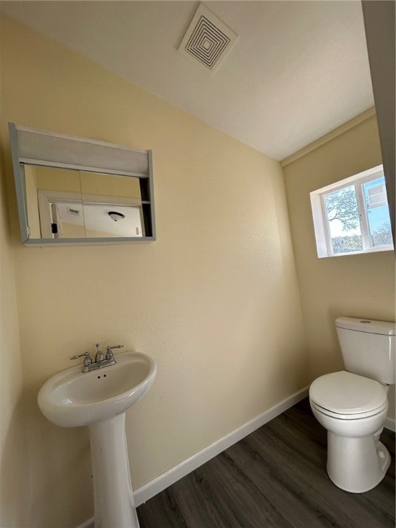 bathroom with wood-type flooring, sink, and toilet