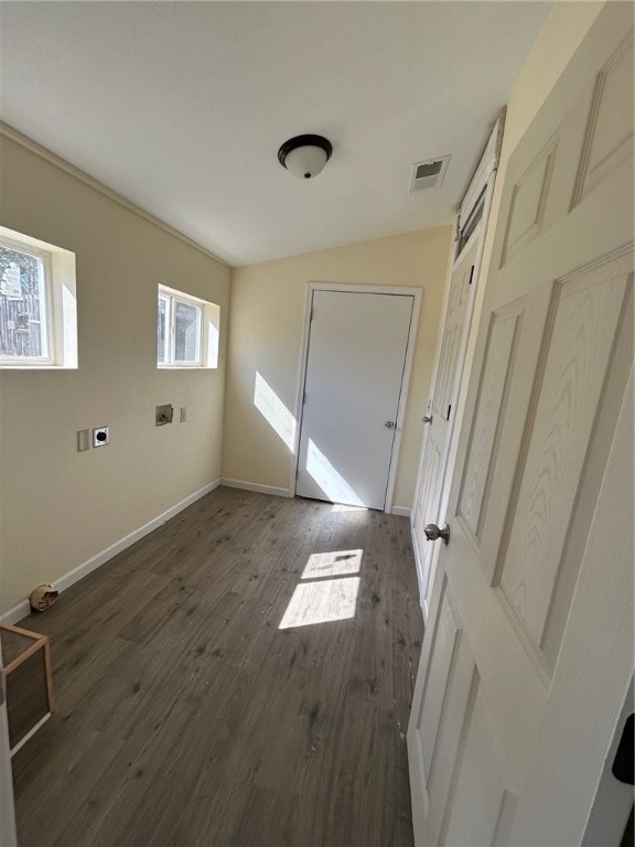 interior space with dark wood-type flooring and washer hookup