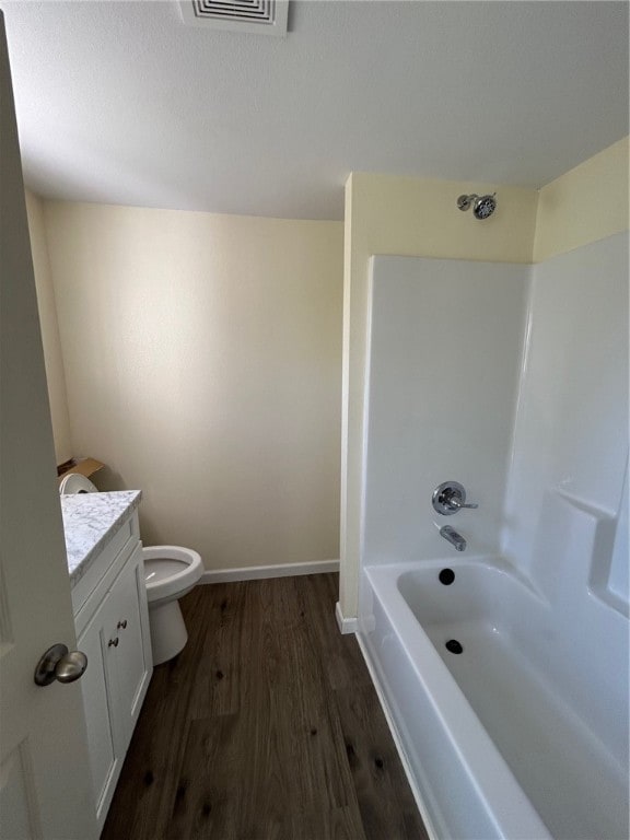 full bathroom featuring shower / tub combination, hardwood / wood-style flooring, toilet, and vanity