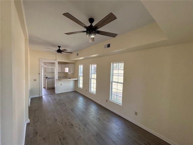 unfurnished living room featuring ceiling fan and hardwood / wood-style flooring