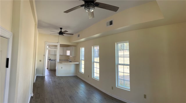 unfurnished living room featuring ceiling fan and dark hardwood / wood-style floors