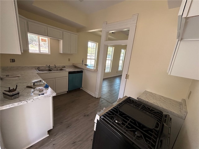 kitchen with black range with gas cooktop, sink, dark hardwood / wood-style floors, white cabinets, and stainless steel dishwasher