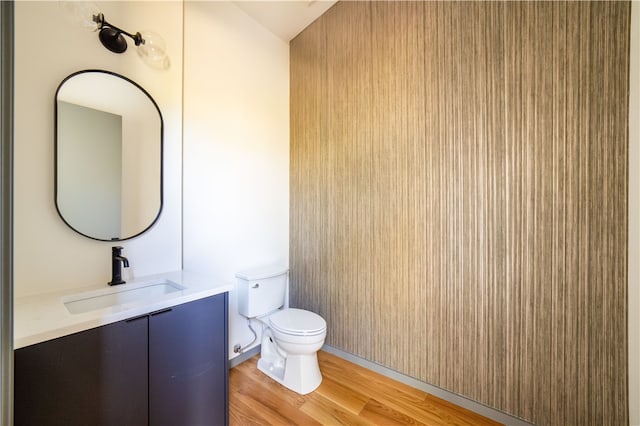 bathroom featuring hardwood / wood-style floors, vanity, and toilet