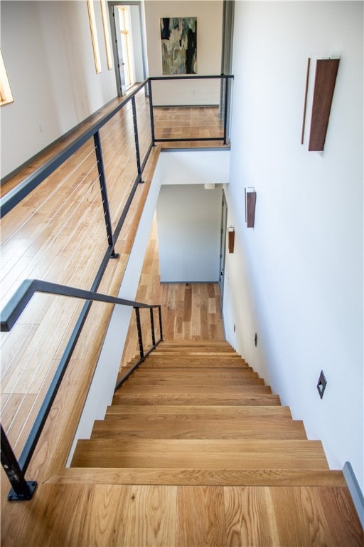 stairs featuring hardwood / wood-style floors