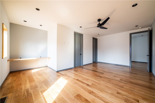 unfurnished room with light hardwood / wood-style floors and ceiling fan