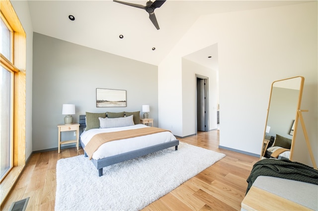 bedroom featuring ceiling fan, vaulted ceiling, and light wood-type flooring