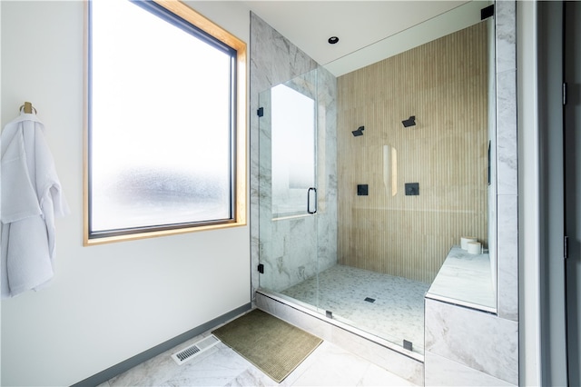 bathroom with a shower with door