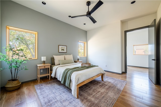 bedroom with ceiling fan and light hardwood / wood-style floors