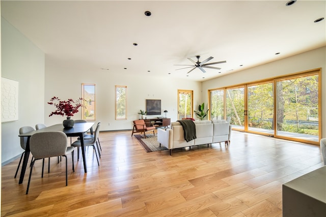 living room with light hardwood / wood-style flooring and ceiling fan