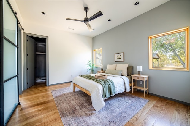 bedroom with ceiling fan and light hardwood / wood-style floors