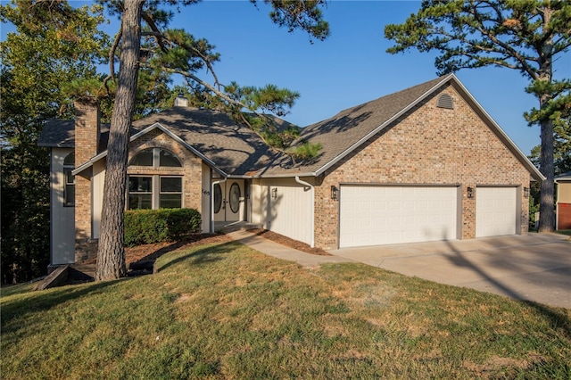 view of front of home featuring a garage and a front lawn