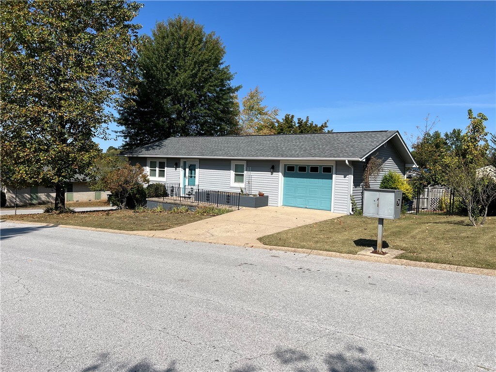 ranch-style house with a garage and a front yard