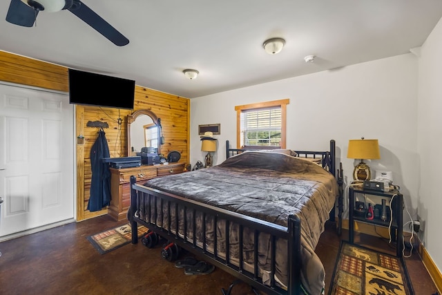 bedroom featuring wood walls and ceiling fan