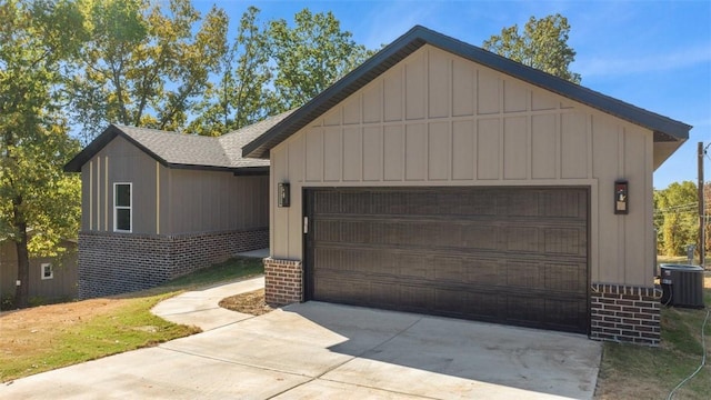 view of front of property with central AC unit and a garage