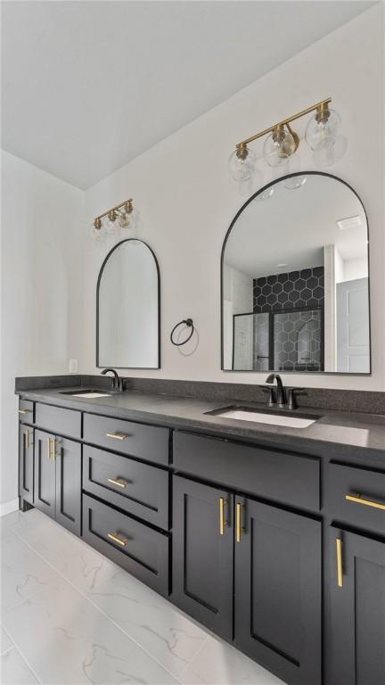 bathroom featuring a shower and vanity