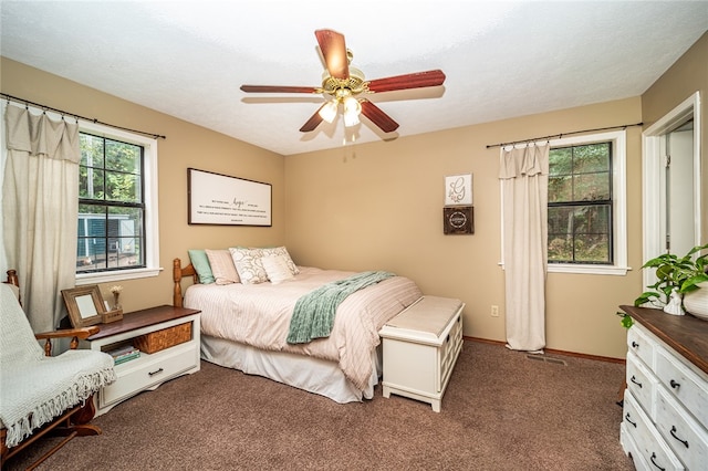 bedroom featuring dark carpet and ceiling fan