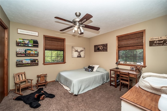 carpeted bedroom with ceiling fan, a textured ceiling, and multiple windows