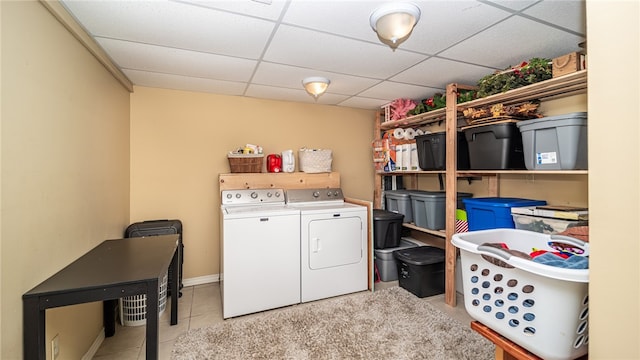 laundry area featuring washer and dryer and light tile patterned floors