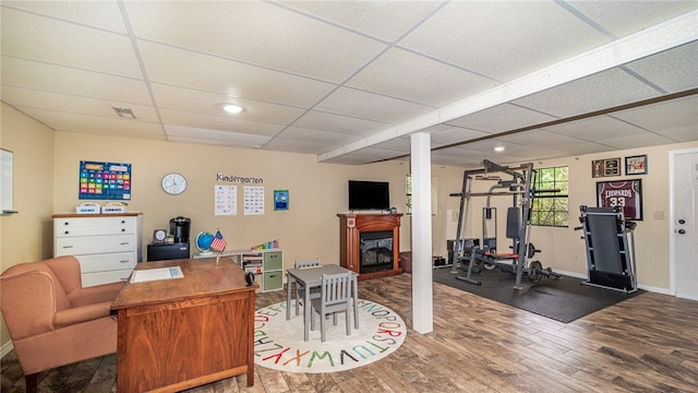 office space with hardwood / wood-style floors and a paneled ceiling