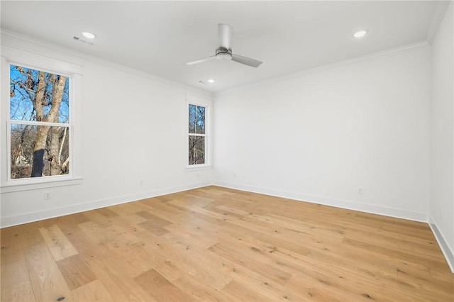 empty room featuring ceiling fan, light hardwood / wood-style flooring, and crown molding