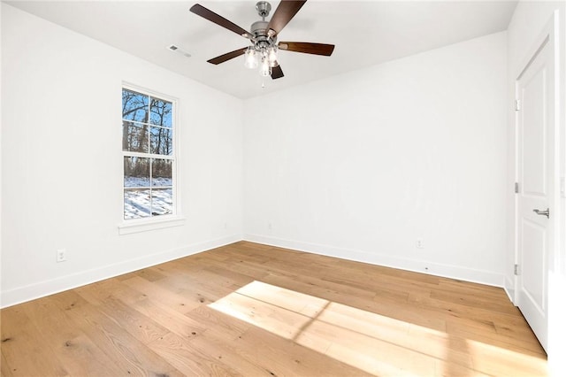 empty room featuring ceiling fan and hardwood / wood-style floors