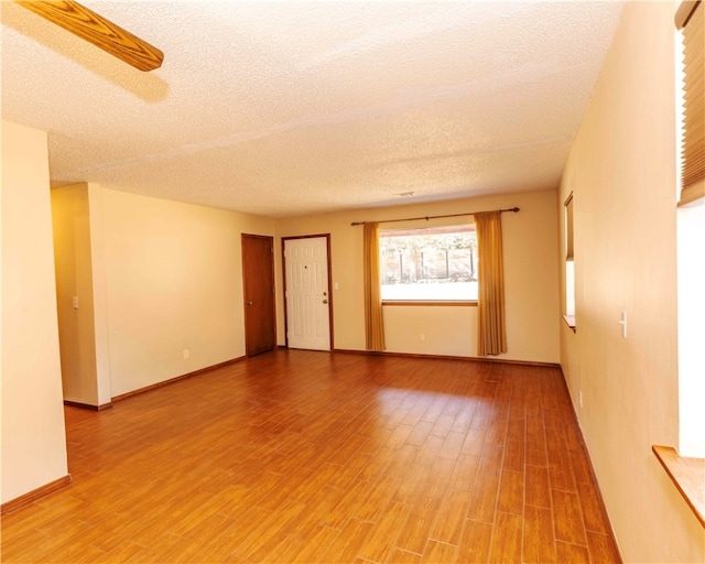 spare room with hardwood / wood-style flooring and a textured ceiling