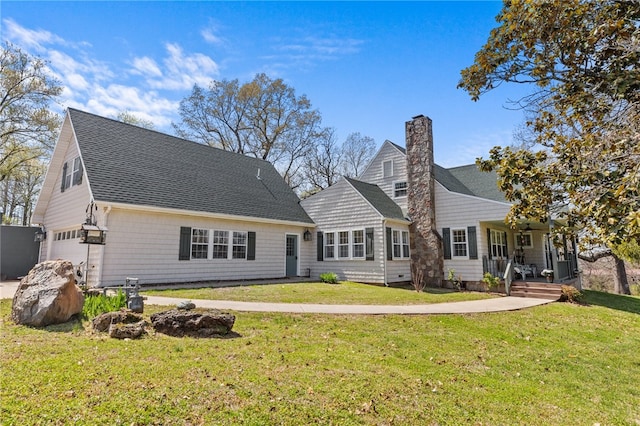 back of house featuring a yard and a garage