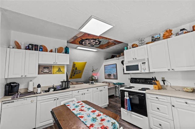 kitchen featuring white appliances, a textured ceiling, dark wood-type flooring, and white cabinetry