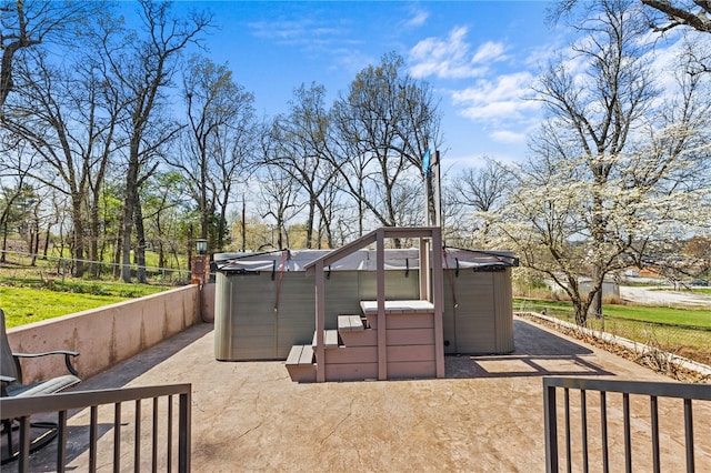 view of patio / terrace with a hot tub