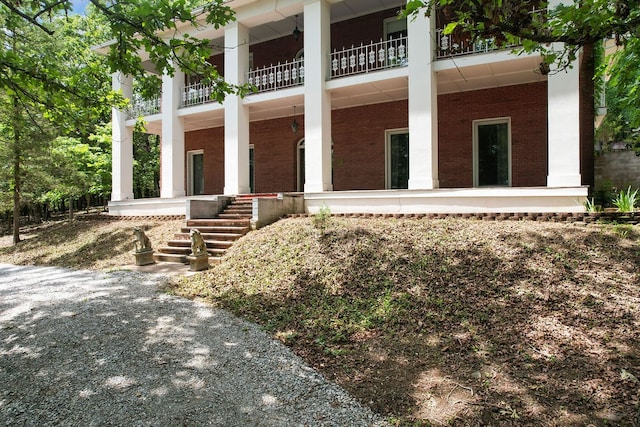 back of house featuring a balcony