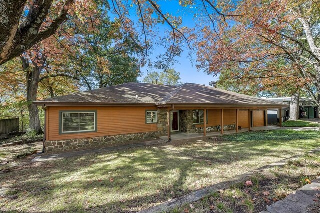 rear view of house featuring a patio and a yard