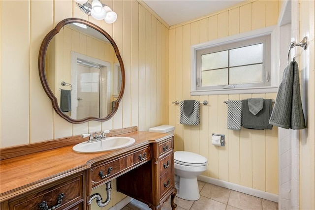 bathroom with vanity, toilet, and tile patterned floors