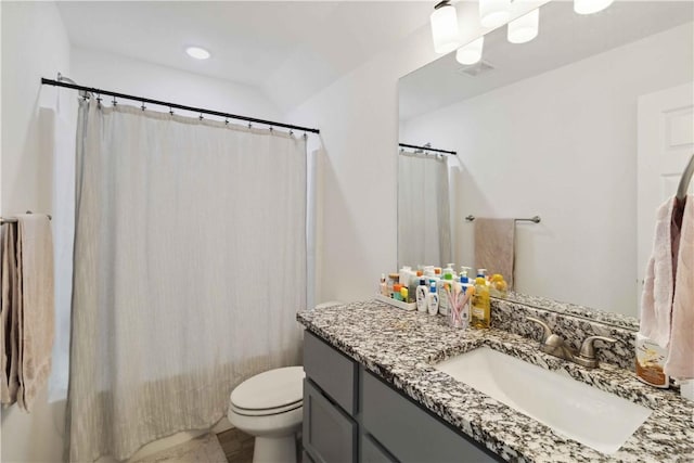 bathroom with toilet, curtained shower, visible vents, and vanity