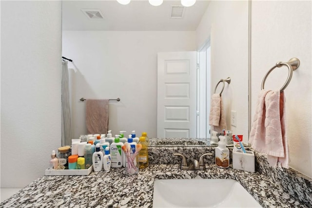 bathroom featuring visible vents, a shower with curtain, and vanity