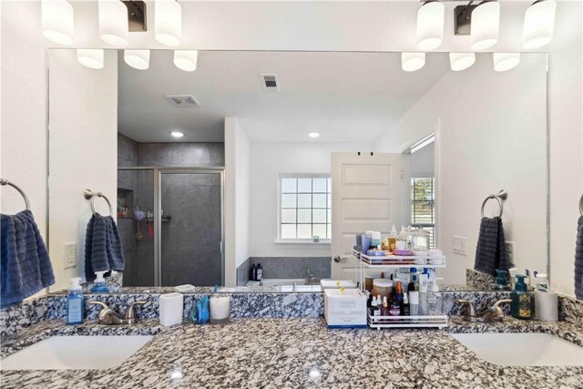 full bathroom with visible vents, a shower stall, a garden tub, and vanity