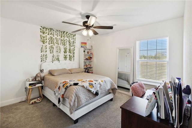 carpeted bedroom with a ceiling fan and baseboards