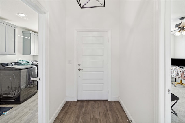 corridor featuring light hardwood / wood-style flooring and washer and dryer