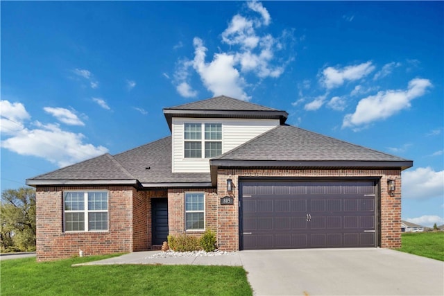 view of front property with a garage and a front lawn