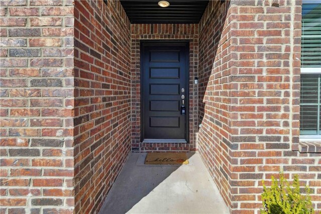 property entrance with brick siding
