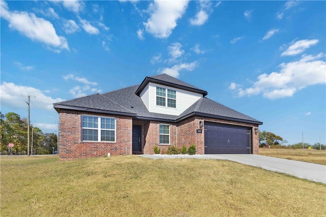 view of front of property featuring a front lawn and a garage