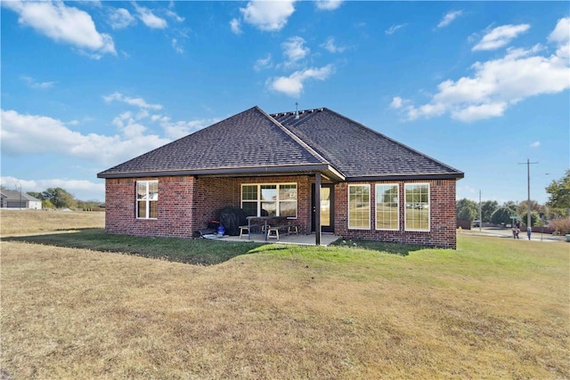 back of house featuring a yard and a patio