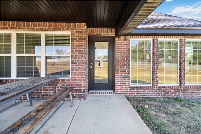 property entrance featuring brick siding