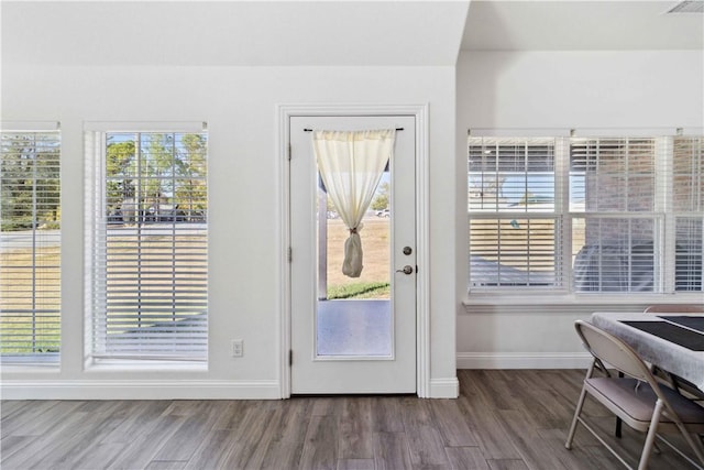 doorway to outside featuring visible vents, wood finished floors, and baseboards
