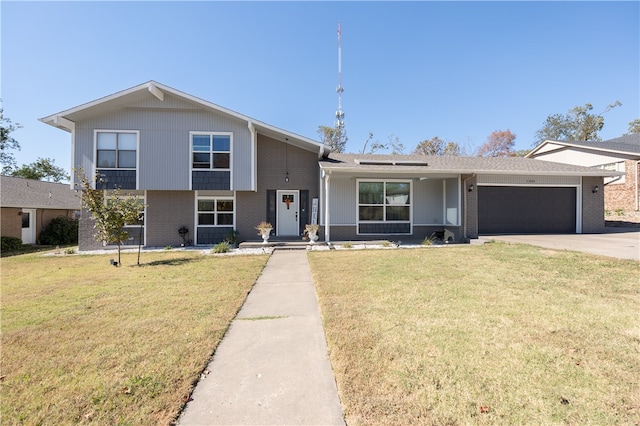 tri-level home featuring a front yard and a garage